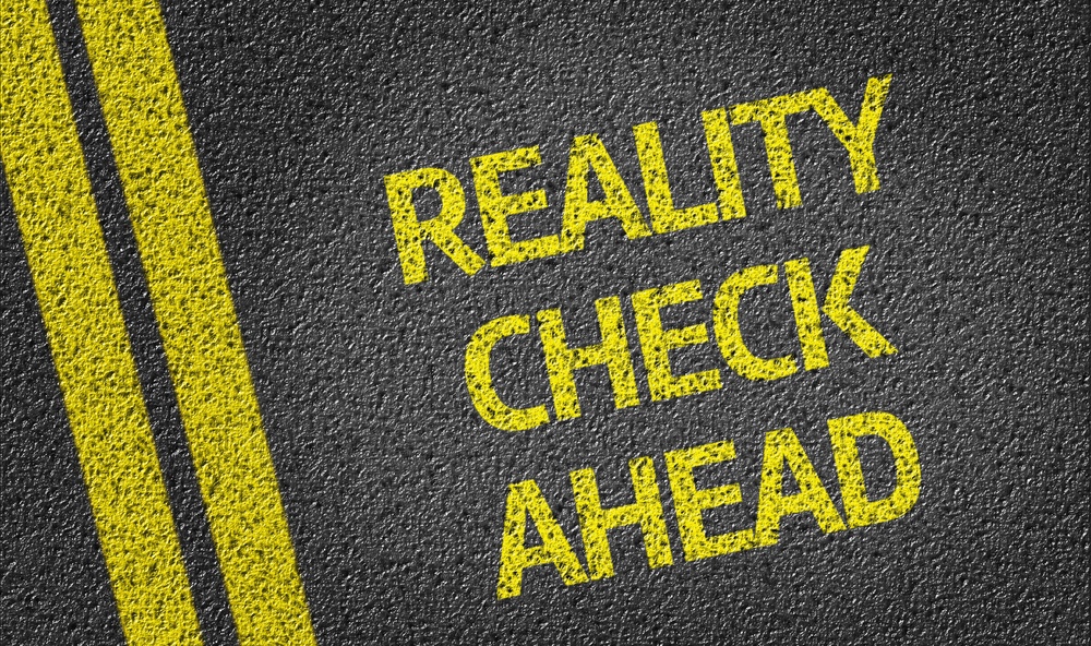 Reality Check Ahead Written On The Road